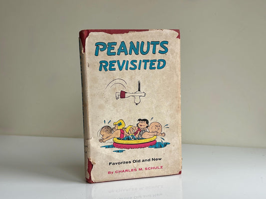 Libro vintage “Peanuts Revisited” (1959) – Charles M. Schulz, Snoopy y Charlie Brown, edición original con sobrecubierta